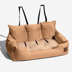 a dog bed with three pillows on it