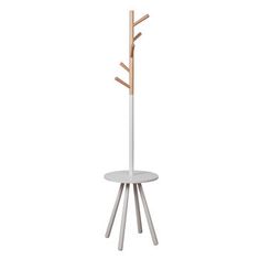 a white coat rack with three wooden branches on the top and two round tables below it