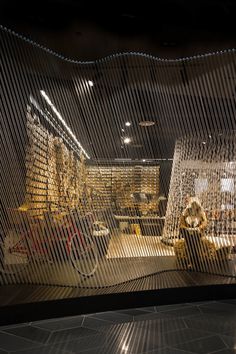 a room filled with lots of different types of furniture and decor on display in front of a glass wall