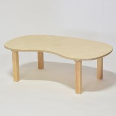 an oval shaped table with wooden legs on a white background