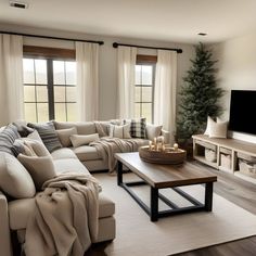 a living room filled with furniture and a flat screen tv on top of a wooden table