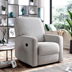 a living room with a chair, table and bookshelves on the wall behind it