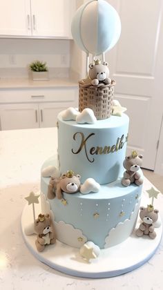 a blue cake with teddy bears on it and a hot air balloon in the sky