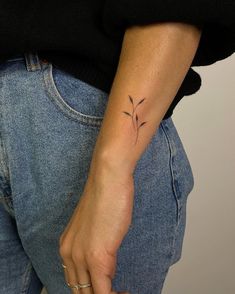 a woman with a small tattoo on her arm