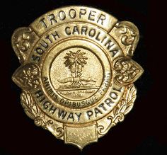 a gold badge with the words trooper south carolina fishway patrol written in black on it