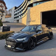 a black car parked in front of a building