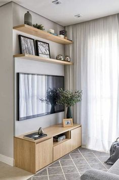 two pictures of a living room with white curtains and black and white chevron rugs