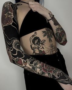 a woman with tattoos on her stomach and arm