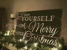 a christmas mantle with garland and lights on it that says have yourself a merry little christmas