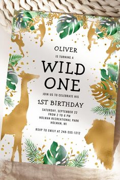 an animal themed birthday party with gold foil and greenery on the front, featuring giraffes