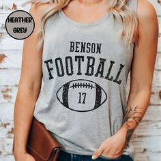 Elevate your game day apparel with this customized tank top with your players number & school mascot.  Makes for a Perfect gift-for football mom on those hot game days! These Tanks are made of high-quality cotton & polyester.  Thank you for browsing our shop, we hope you find something you enjoy! PRODUCT Women's next level 1533 Racerback Tank Top -Scooped neckline -classic fit -super soft & stretchy How to order: *Please review all photos in listing *Select the item size and color, quantity *Pro Team Spirit Tops With Team Name For Tailgating, Team Spirit Tops For Tailgating, Sleeveless Varsity Top For Game Day, Customizable Team Spirit Tops For Game Day, Football Season Sports Fan Tops For Team Events, Team Spirit Tops For Tailgating During Football Season, Sports Fan Tops For Football Season Team Events, School Spirit Tops For Football Season Tailgating, Sports Fan Tops For Football Season