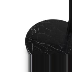 a black marble umbrella stand with a black handle on it's side and a white background