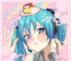 a girl with blue hair wearing headphones and holding her hand up to her face