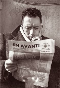 a man reading a newspaper with the caption en avant written on his face