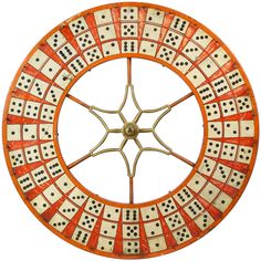 an orange and white clock with black dots in the middle, on a white background