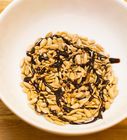 a white bowl filled with oatmeal sitting on top of a wooden table