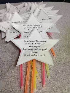 several folded paper stars with writing on them