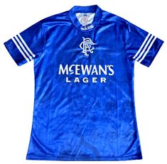 a blue soccer jersey with the name mcewans lager on it and two white stripes