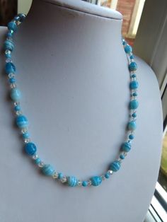 Vintage Light Blue Art & Aurora Borealis Glass Bead Necklace This is a lovely blue glass beads with Aurora Borealis glass beads in between, this necklace is nearly 19" long with silver tone metal screw barrel fastener. The main bead is nearly 1/2" and has small bicone aurora borealis spacer beads.. This vintage necklace is in a good condition. (21.07.24 B) Blue Czech Glass Necklace With Large Beads, Blue Polished Glass Bead Jewelry, Light Blue Glass Bead Jewelry, Blue Glass Round Bead Necklaces, Blue Glass Beaded Necklaces, Blue Round Beaded Glass Crystal Necklace, Blue Czech Glass Necklaces With Polished Beads, Blue Beaded Czech Glass Necklaces, Blue Czech Glass Necklaces With Round Beads