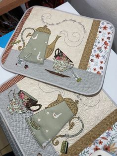 two place mats with teapots on them