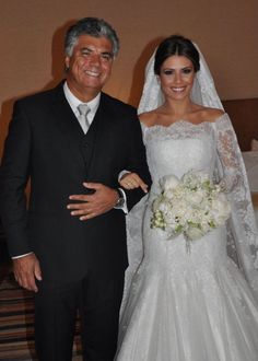 the bride and groom are posing for a photo