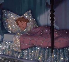 a bed covered in lots of glitter next to a night stand