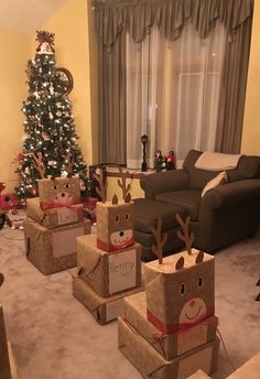 christmas presents are wrapped in brown paper with reindeer faces on them and tied to boxes