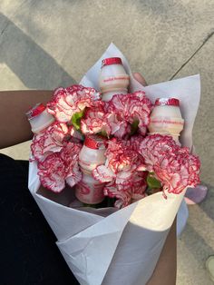 a person holding a bouquet of flowers in their hand