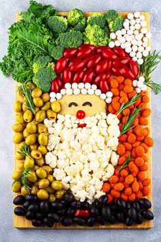 an image of a santa clause made out of veggies on a cutting board