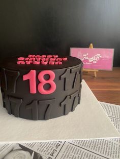 a birthday cake with the number eighteen on it is sitting on top of a table