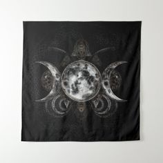 a tapestry with three phases of the moon