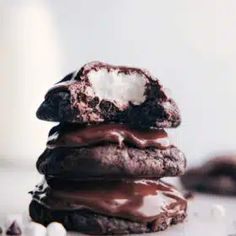 a stack of cookies covered in chocolate and marshmallows