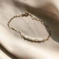 "V I V E Vive is the Latin word for live // 14k gold-filled chain bracelet with either freshwater pearl or turquoise. Perfect on its own or stacked! Both styles have matching necklaces! Check out the ALEXANDRA and UDINA necklaces~ great for gifting. Sized by circumference: Extra Small: 6\" Small: 6.5\" Medium: 7\" Large: 7.5\" Extra Large: 8\" *This bracelet comes with a 0.5\" extender chain which is not included in these measurements. We suggest you measure for this bracelet by wrapping a measu Simple Jubilee Bracelets For Everyday, Simple Everyday Jubilee Bracelets, Simple Jubilee Bracelet For Everyday, Simple Jubilee Bracelet, Classic Pearl Bracelet With Adjustable Chain For Everyday, Dainty Beaded Bracelet With Extender For Everyday, Classic Everyday Pearl Bracelet With Adjustable Chain, Everyday Beaded Bracelets With Pearl Charm, Everyday Beaded Bracelet With Pearl Charm