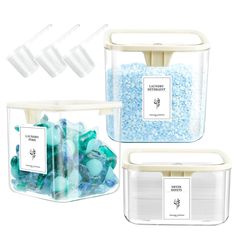 three storage containers filled with blue and green candies next to each other on a white background