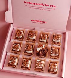 a box filled with brownies covered in frosting