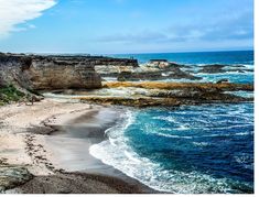 the beach is next to an ocean cliff