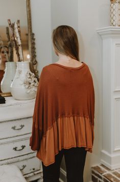 This is an orange long sleeve oversized top.The model is wearing a size small. Chic Oversized Fall Tops, Trendy Brown Long Sleeve Top For Fall, Spring Layering Orange Sweater, Orange Long Sleeve Sweater For Spring, Chic Orange Long Sleeve Sweater, Trendy Orange Sweater For Layering, Chic Orange Long Sleeve Blouse, Oversized Brown Long Sleeve Top, Oversized Top For Layering In Fall