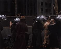 a group of people standing next to each other with umbrellas on their heads in the rain