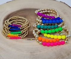 ⛱Set of 8 bracelets adorned with neon glass beads🌊  *Please do not put harsh chemicals such as perfumes or lotion directly on your jewelry. Do not submerge gold fill  beads in water. With time, gold filled beads can tarnish if not taken care for properly. We are not responsible for replacing tarnished items. Neon Round Bead Bracelets For Gifts, Neon Bracelets With Round Beads For Gift, Neon Beaded Bracelets Gift, Neon Beaded Bracelet Gift, Gold Bracelets With 8mm Beads For Party, Party Gold Bracelet With 8mm Beads, Neon Beaded Bracelets As Gift, Neon Jewelry With Colorful Beads As A Gift, Trendy Neon Beaded Bracelets For Gifts