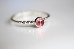 This lovely pink tourmaline ring has a rich, romantic feel to it. I have set this natural 4mm round pink tourmaline gemstone atop of a beaded solid sterling silver band  The pictured finish is highly polished for a very reflective shine.  Pictured Material Information: Natural Gemstone 4mm round smooth Color: Light to deep Pink Gemstone: Pink Tourmaline Metals: .925 sterling silver 1 (16 gauge 1.3mm) beaded band Please contact me with any questions! ★ IMPORTANT SHIPPING & PRODUCTION DETAILS!! ★ Gemstone Stacking Ring, Romantic Rings, Pink Tourmaline Ring, Natural Gemstone Ring, Black Gift Boxes, Tourmaline Ring, Pink Gemstones, Deep Pink, Pink Ring