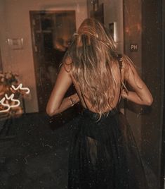 the back of a woman's head in a black dress