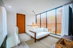 a living room filled with furniture next to a window