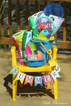 a yellow chair with some items in it on a wooden deck next to a sign that says summer