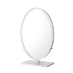 a round mirror sitting on top of a metal stand