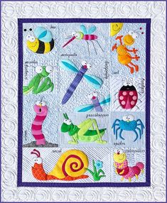 a quilted wall hanging with bugs and insects on it