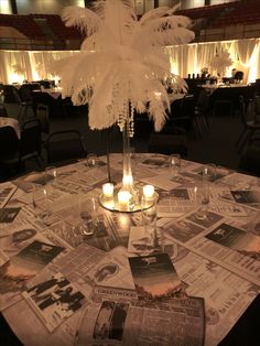 the centerpiece is made out of newspaper and lit candles