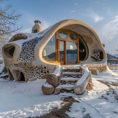 a house made out of rocks in the snow