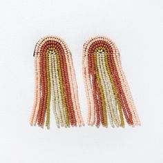 With rainbow-shaped earrings + a positive attitude, there's nothing you can't do. Our signature glass seed beads are making the world a more boho-cool place one ear at a time. Blush pink, rust, citron + ivory beads bring colorful movement and eccentric greatness. So whether you're pairing them with a cocktail dress or denim jumpsuit, you're sure to make a bold statement. 2.25"L Made By Artisans In India Glass + Brass Hypoallergenic