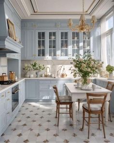 a kitchen with blue cabinets and white counter tops, an island in the middle is surrounded by wooden chairs