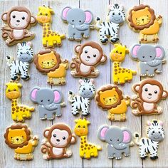 the cookies are decorated with animals and zebras on wooden boards, as well as other decorations